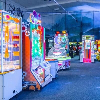 Row of classic and modern arcade machines in a gaming center in Cambridge New Zealand
