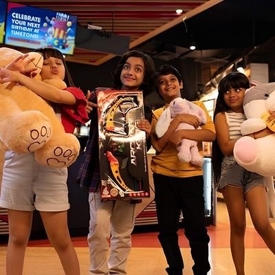 Kids holding arcade prizes at an entertainment center in Cambridge New Zealand