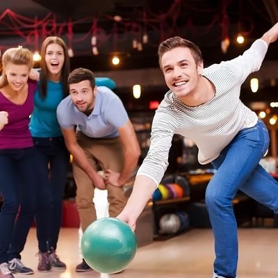 Friends enjoying a bowling game and cheering in a modern bowling alley in Cambridge New Zealand