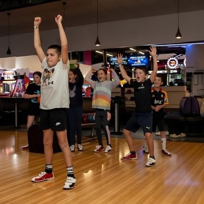 Group celebrating and enjoying bowling together in Cambridge New Zealand