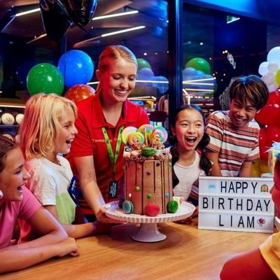 Kids celebrating a birthday party with cake at an entertainment center in Cambridge New Zealand