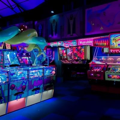 Neon-lit arcade game machines at an entertainment center in Cambridge New Zealand